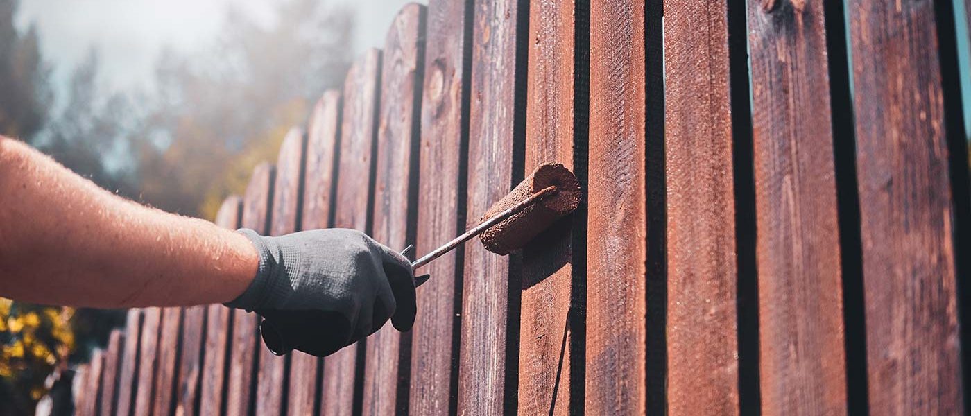 diligent-man-is-painting-fence-with-brush-2021-08-28-11-14-27-utc